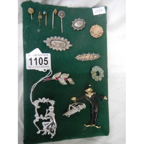 1105 - A good lot of brooches and stick pins including some silver.