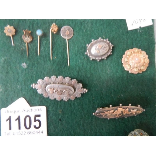 1105 - A good lot of brooches and stick pins including some silver.