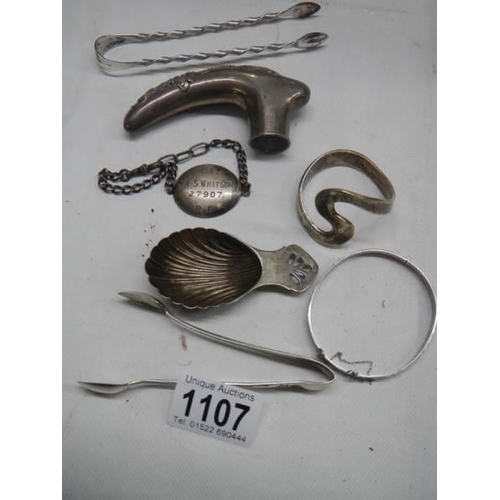 1107 - A mixed lot including silver bangle and various plated items.