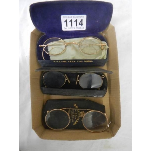 1114 - Three cased pairs of vintage spectacles.