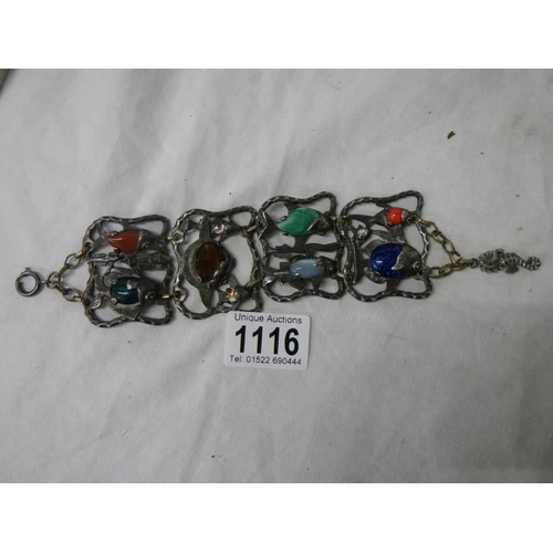 1116 - An antique metal bracelet featuring fish inset with various gem stones.