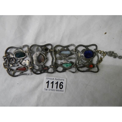 1116 - An antique metal bracelet featuring fish inset with various gem stones.