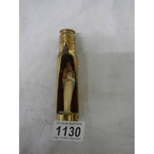 1130 - A item of trench art being a gun shell with figure of the Virgin Mary inside.