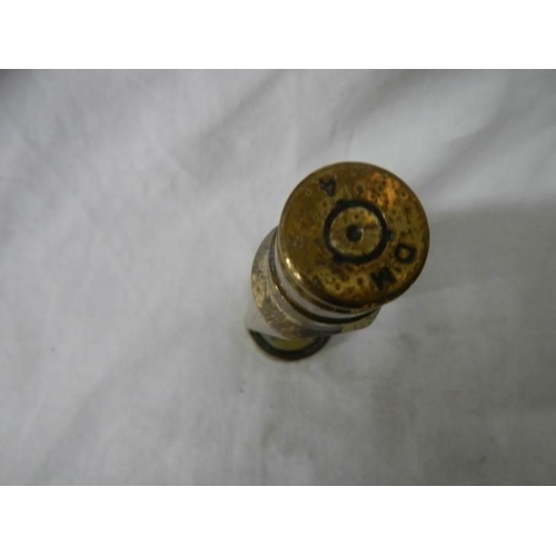 1130 - A item of trench art being a gun shell with figure of the Virgin Mary inside.