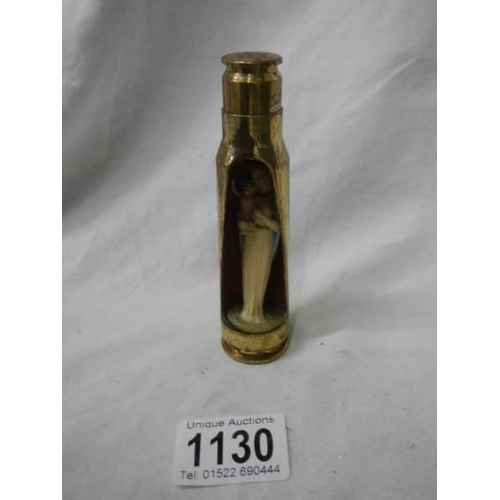 1130 - A item of trench art being a gun shell with figure of the Virgin Mary inside.