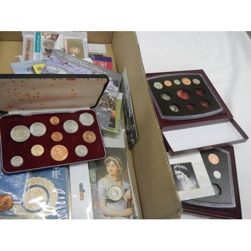 1147 - A large box of assorted coins and coin sets.