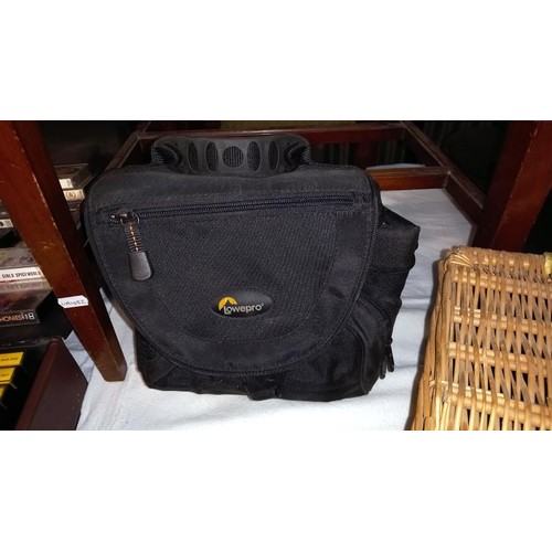 912 - A wicker basket, a 2 Lowepro camera bag, a Lowepro camera case & a Canon camera