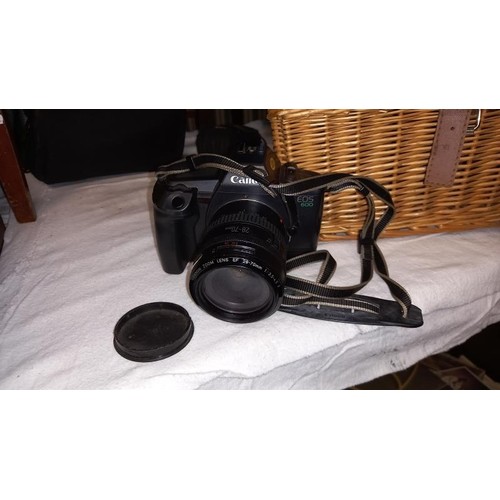 912 - A wicker basket, a 2 Lowepro camera bag, a Lowepro camera case & a Canon camera