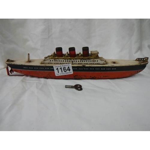 1164 - An early 20th century tin plate clockwork ocean liner by Arnold, Germany, 32 cm long.