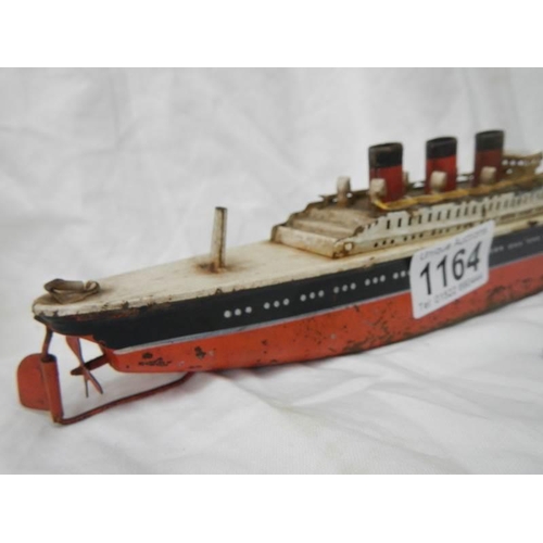 1164 - An early 20th century tin plate clockwork ocean liner by Arnold, Germany, 32 cm long.