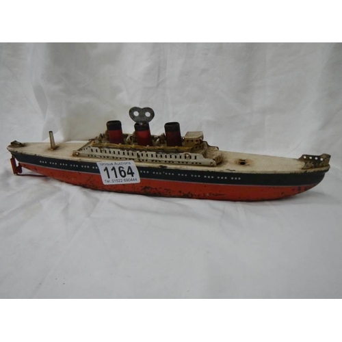 1164 - An early 20th century tin plate clockwork ocean liner by Arnold, Germany, 32 cm long.