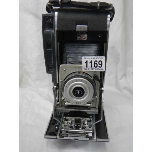 1169 - A vintage folding Polaroid camera.