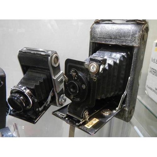 1185 - Two vintage folding camera's and a Polaroid camera.