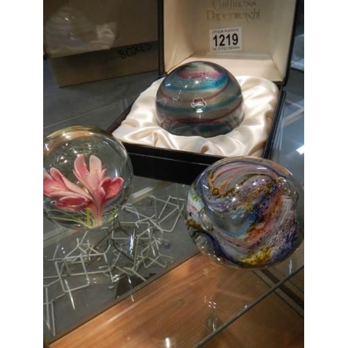 1219 - A boxed Caithness glass paperweight and two others.