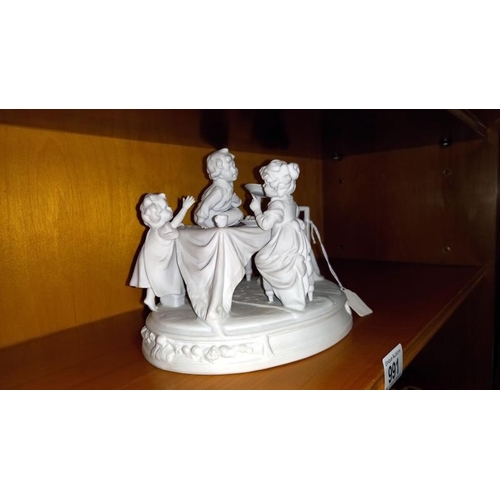 991 - A mid 20th century Parian figure depicting a children's tea party.