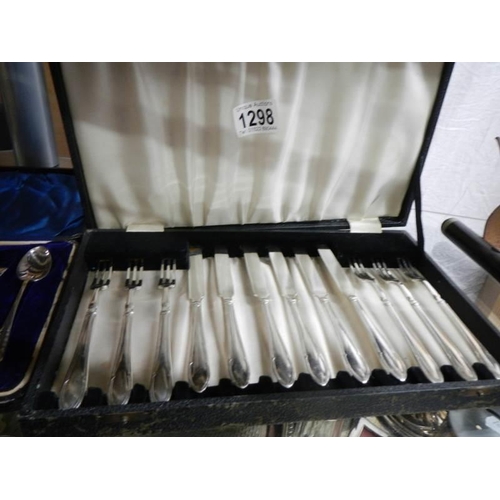 1298 - A cased set of dessert knives and forks and a cased set of teaspoons with sugar tongs.