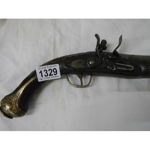 1329 - A 19th century flint lock pistol with brass inlay.