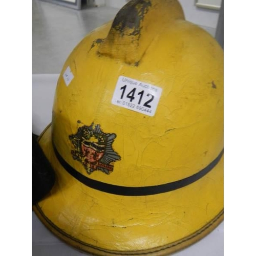 1412 - A vintage Humberside fire brigade helmet and a jacket.