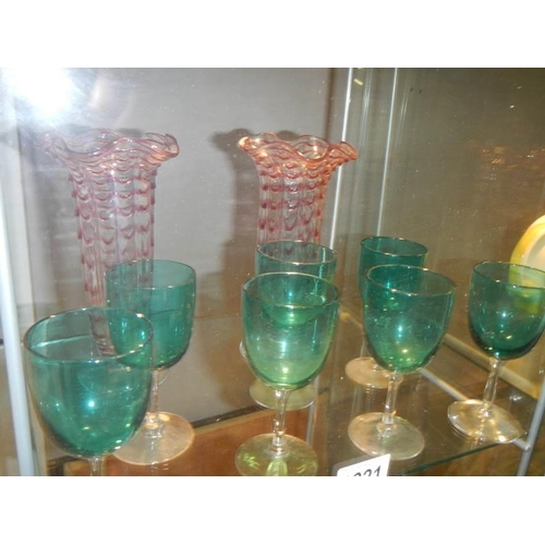 1221 - A pair of overlaid glass vases and a quantity of green glass goblets.