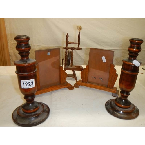 1223 - A pair of Edwardian wooden photo frames, pair of wooden candlesticks and a miniature spinning wheel.