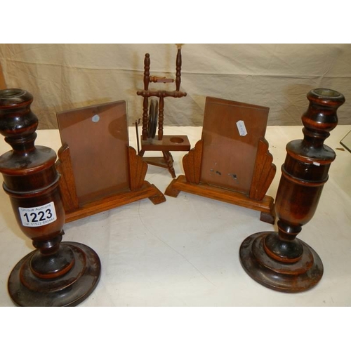 1223 - A pair of Edwardian wooden photo frames, pair of wooden candlesticks and a miniature spinning wheel.