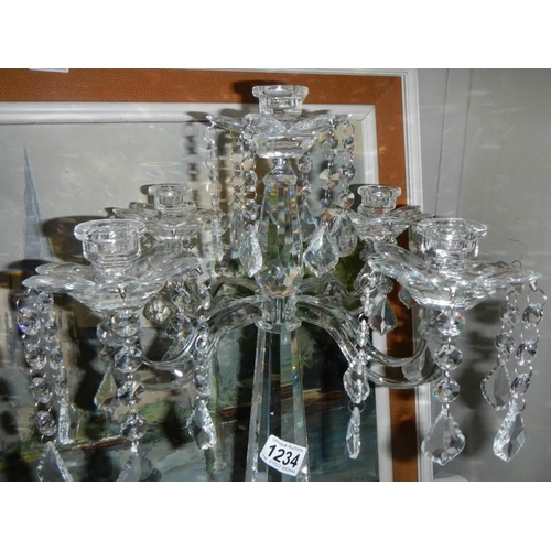 1234 - A glass five branch table centrepiece candle holder.