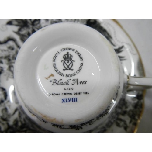 1243 - A Royal Crown Derby 'Black Aves' pattern dinner set, A1310, approximately 46 pieces.