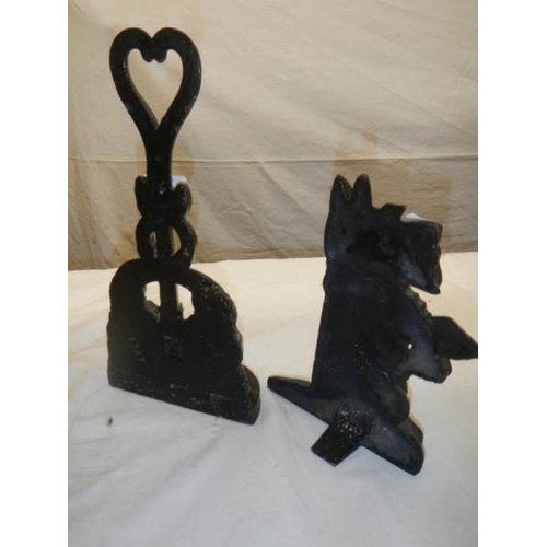 1258 - Two old cast iron door stops.