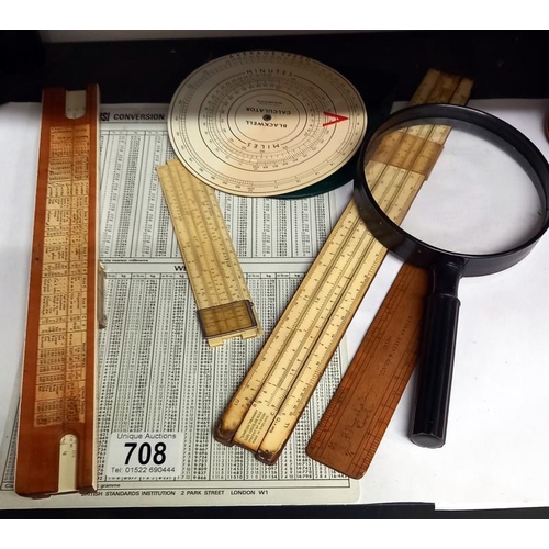 708 - A quantity of vintage slide rules etc. Including magnifying glass