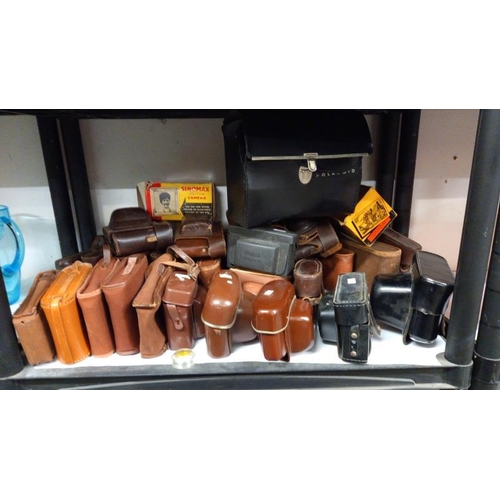 718 - A large quantity of vintage empty camera cases, 4 shelves