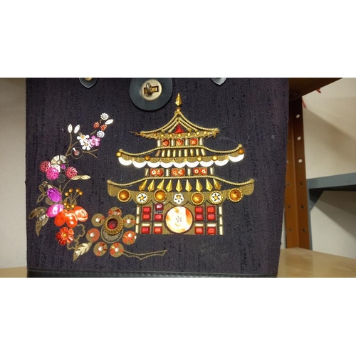 757 - A vintage bag with jewelled Chinese pagoda decoration