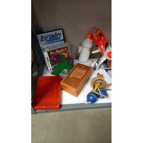 767 - A quantity of vintage games including Larami water pistol, Klee ware doll's house furniture etc.