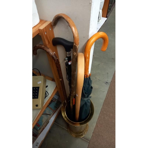 816 - A brass umbrella stand & contents