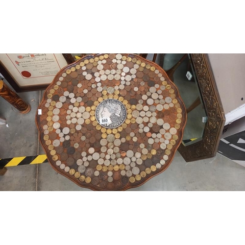 860 - A coffee table with top filled with coins including centre coin, COLLECT ONLY