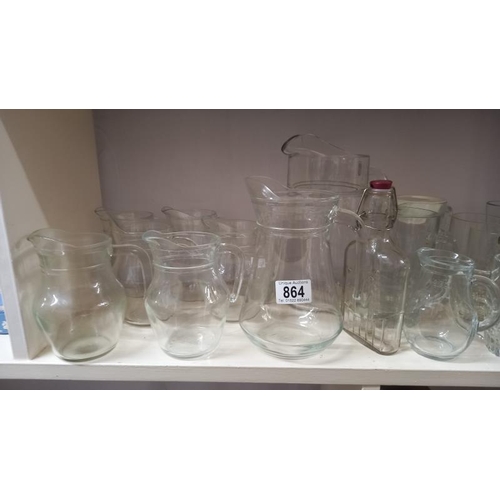 864 - A good lot of glass 'cafe' milk/juice jugs plus other jugs & glasses, COLLECT ONLY