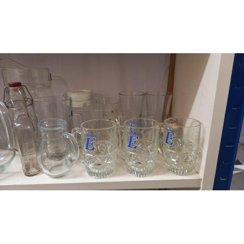 864 - A good lot of glass 'cafe' milk/juice jugs plus other jugs & glasses, COLLECT ONLY