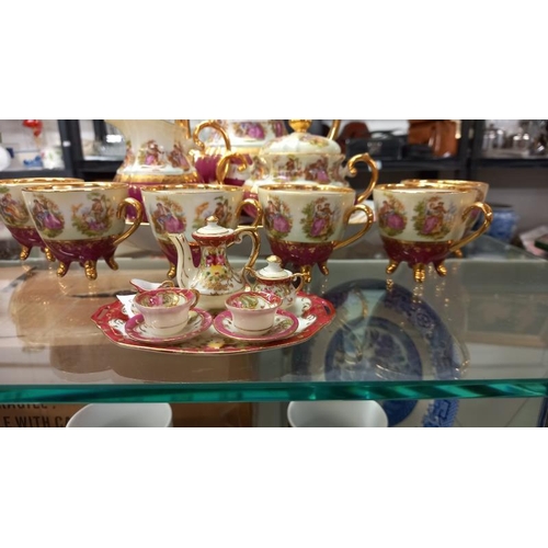 947 - A continental Gloria fine porcelain coffee set plus a miniature set