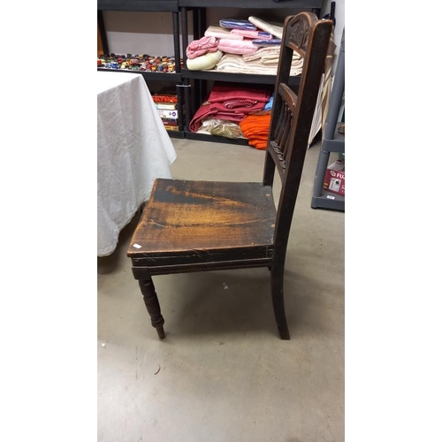 968 - A 19th century oak hall chair with spindle & carved back