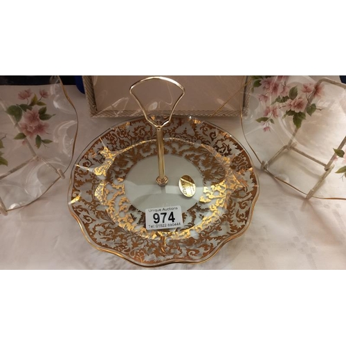 974 - A boxed glass cake stand and 2 other decorative glass plates