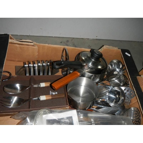 592 - A box of stainless steel kitchen ware.