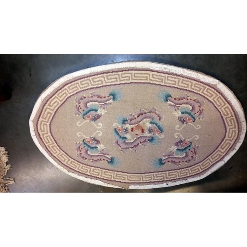 738 - An oval rug depicting dragons - 123cm x 76cm at widest points, COLLECT ONLY