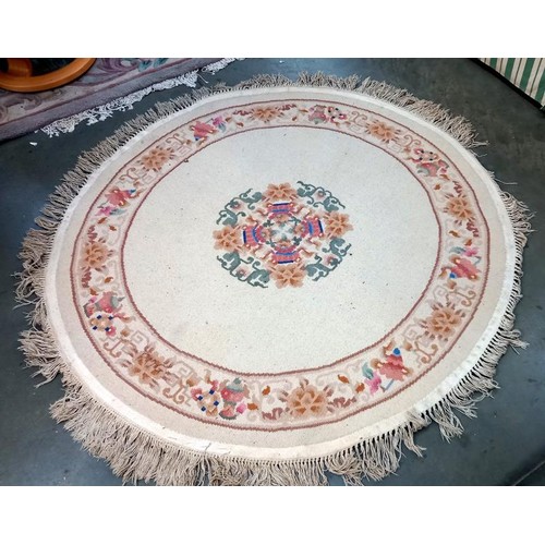 741 - A beige coloured circular rug - 166cm diameter (including tassels) COLLECT ONLY