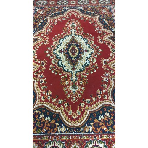 746 - A burgundy patterned coloured rug - 233cm x 170cm COLLECT ONLY