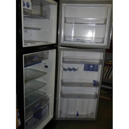 679 - A Whirlpool fridge freezer with stainless front. COLLECT ONLY.