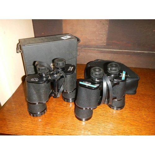 696 - Two cased sets of binoculars.