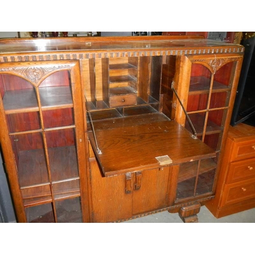 705 - A 1930's oak side by side bureau bookcase, A/F 1 glass panel missing COLLECT ONLY.