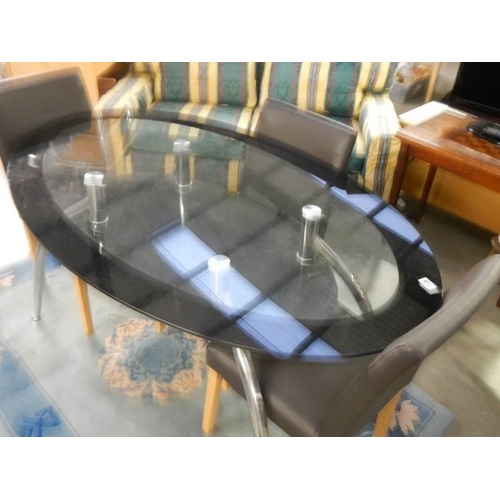 726 - An oval glass top dining table and three chairs, COLLECT ONLY.