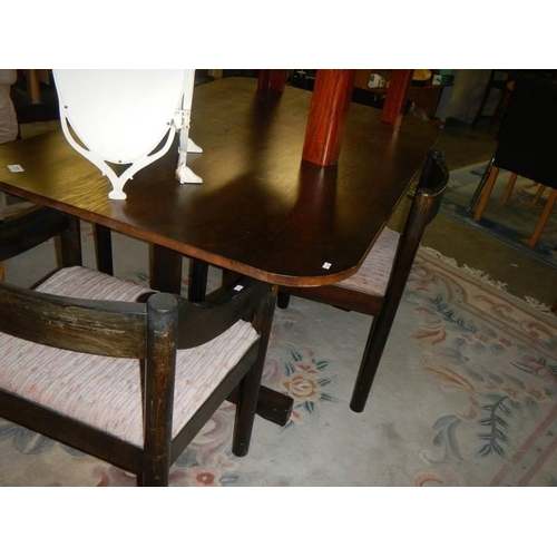 731 - A dark oak dining table and four chairs. COLLECT ONLY.