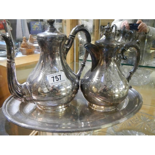 757 - A silver plate teapot and water jug on tray.