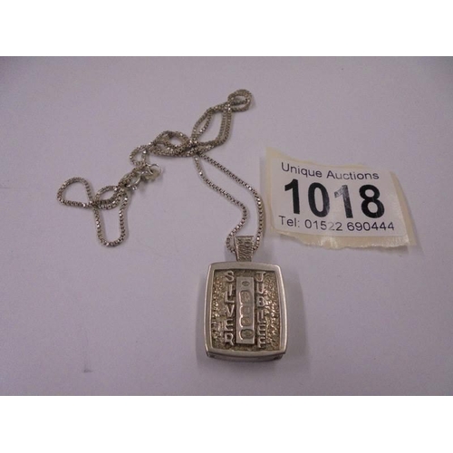 1018 - A silver jubilee pendant on silver chain, 20.8 grams.